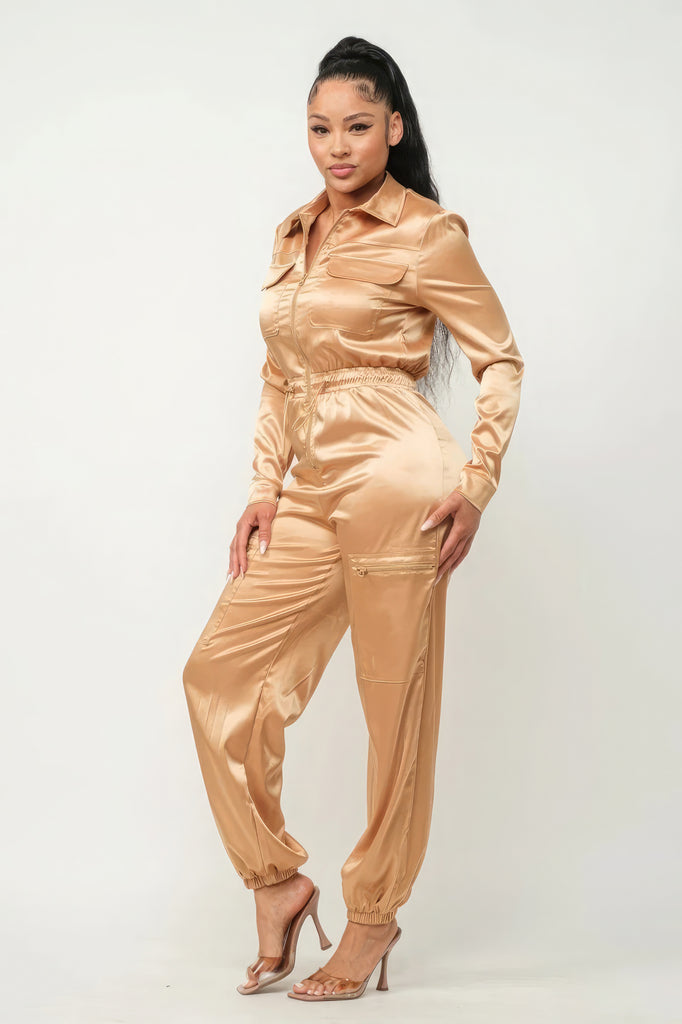 side view of model wearing gold Zip Front Satin Cargo Jogger Jumpsuit