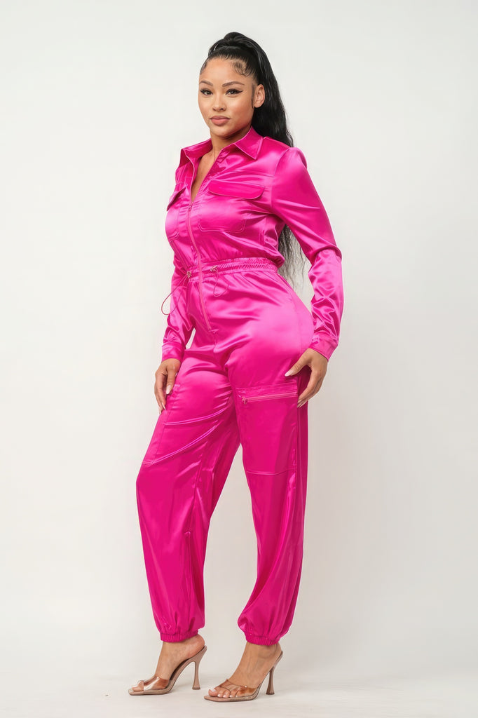 side view of model wearing pink Zip Front Satin Cargo Jogger Jumpsuit