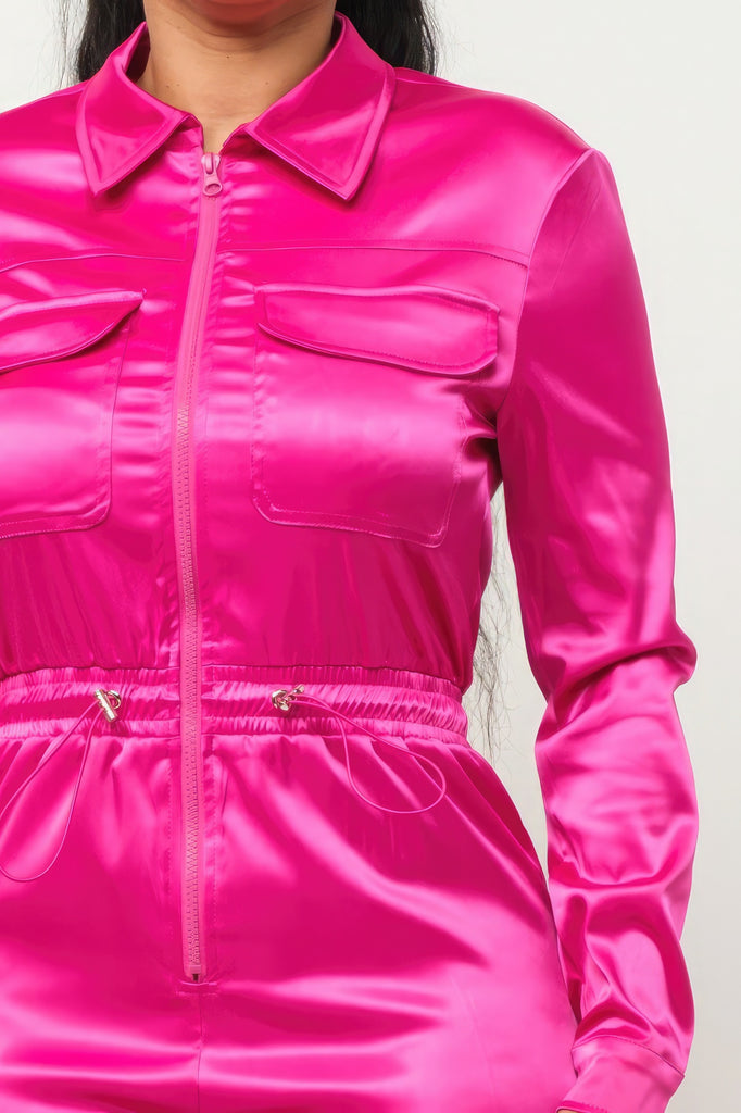 close up of model wearing pink Zip Front Satin Cargo Jogger Jumpsuit