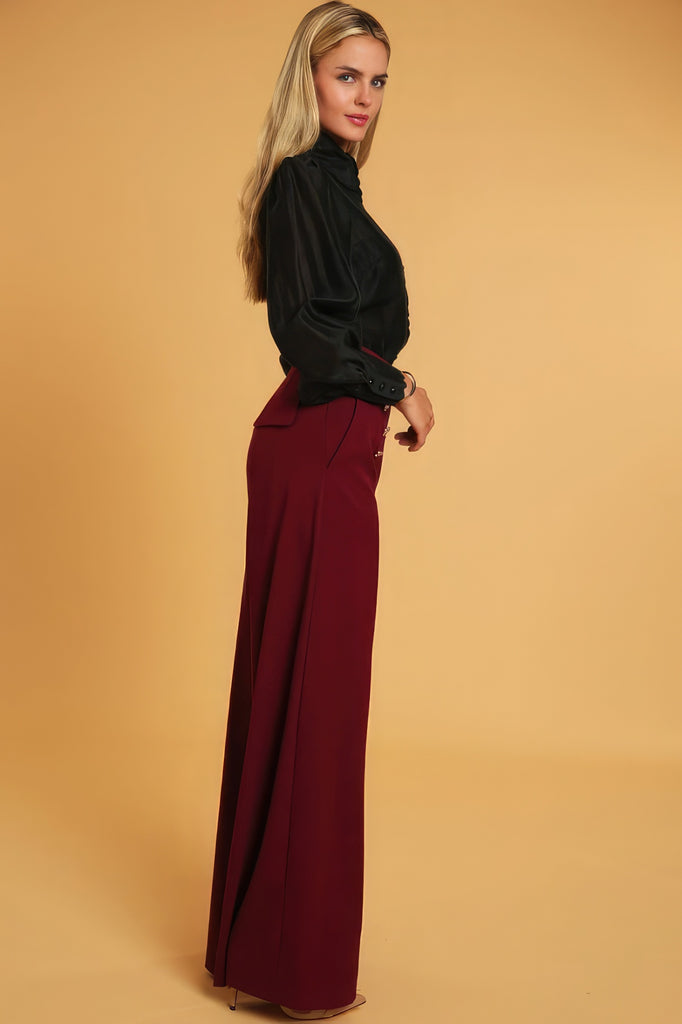 side view of model wearing deep red High Waisted Wide Leg Dress Pants and a black blouse