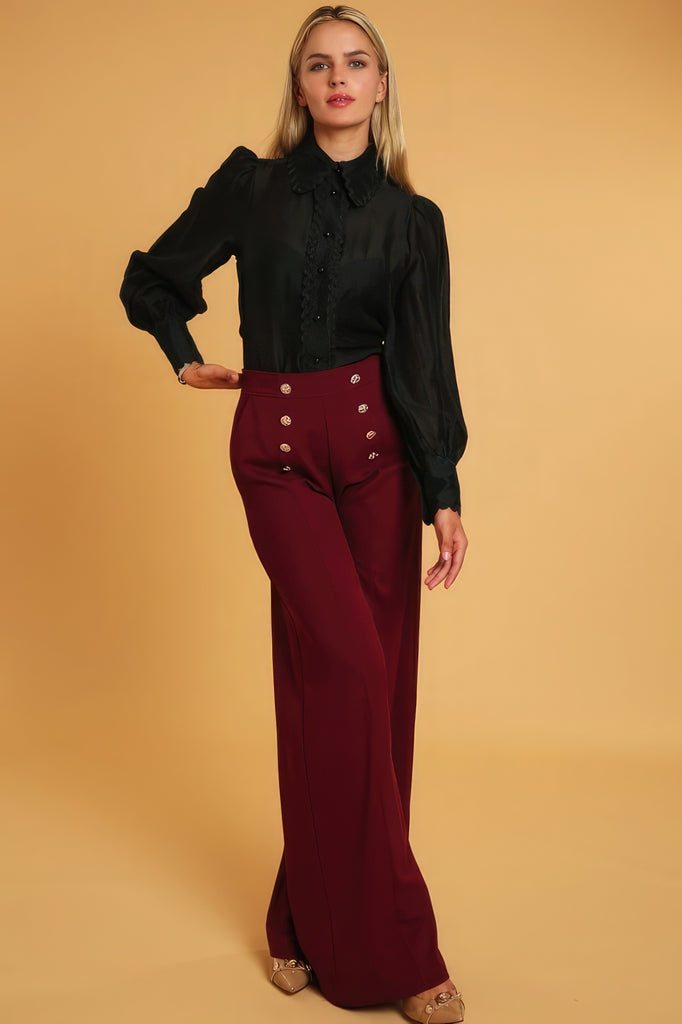 front view of model wearing deep red High Waisted Wide Leg Dress Pants and a black long sleeve blouse