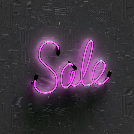 "Sale" written in neon purple script against a Black background.  