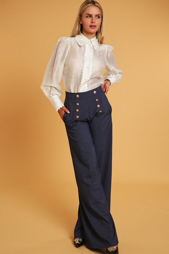 model wearing denim blue High Waisted Wide Leg Dress Pants with a white button down blouse