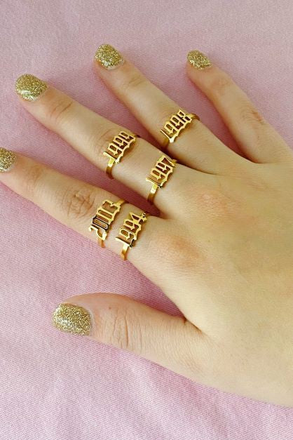 gold Birth Year Rings on model's fingers