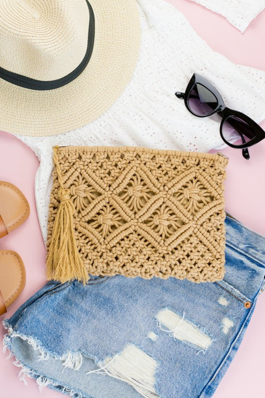 khaki Woven Macrame Tassel Clutch flat lay with shorts, a white top, sunglasses and hat