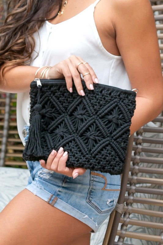 model holding Black Woven Macrame Tassel Clutch