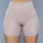 Nude high-waisted shapewear shorts with a seamless front panel for a smooth, sculpted look under clothing