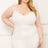 Model wearing white plus size mini dress with rhinestone detail