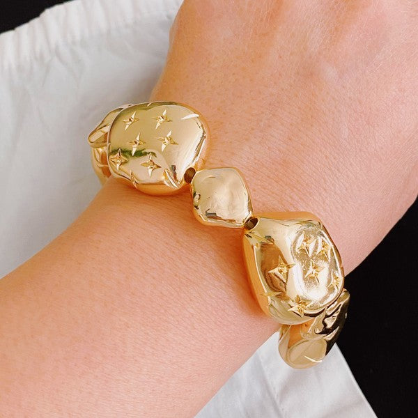 golden starlight design bracelet shown on a model's wrist