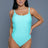 mint green swimsuit features a scoop neckline and thin shoulder straps. The crisscross detailing on the sides adds a stylish touch