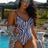 Black One-Piece Zebra Print Swimsuit on model by the pool