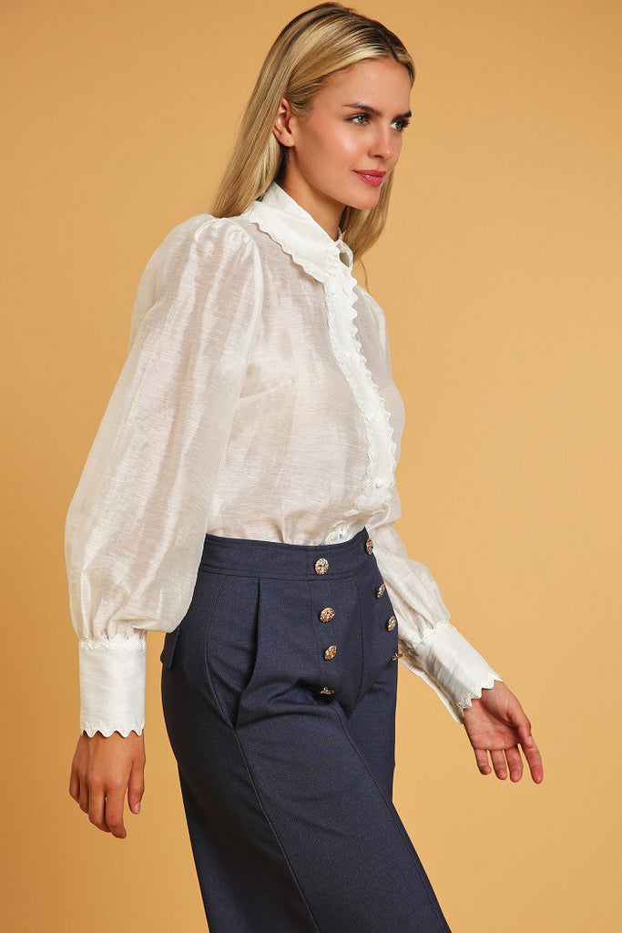 close up of model wearing denim blue High Waisted Wide Leg Dress Pants with a white button down blouse