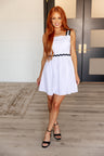 model with red hair wearing Little White Dress with Black Trim front view. divvastyle.net