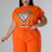 model wearing orange Plus Size High Waisted Short Set with rhinestone graphic design