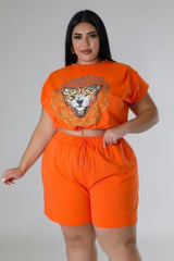 model wearing orange Plus Size High Waisted Short Set with rhinestone graphic design