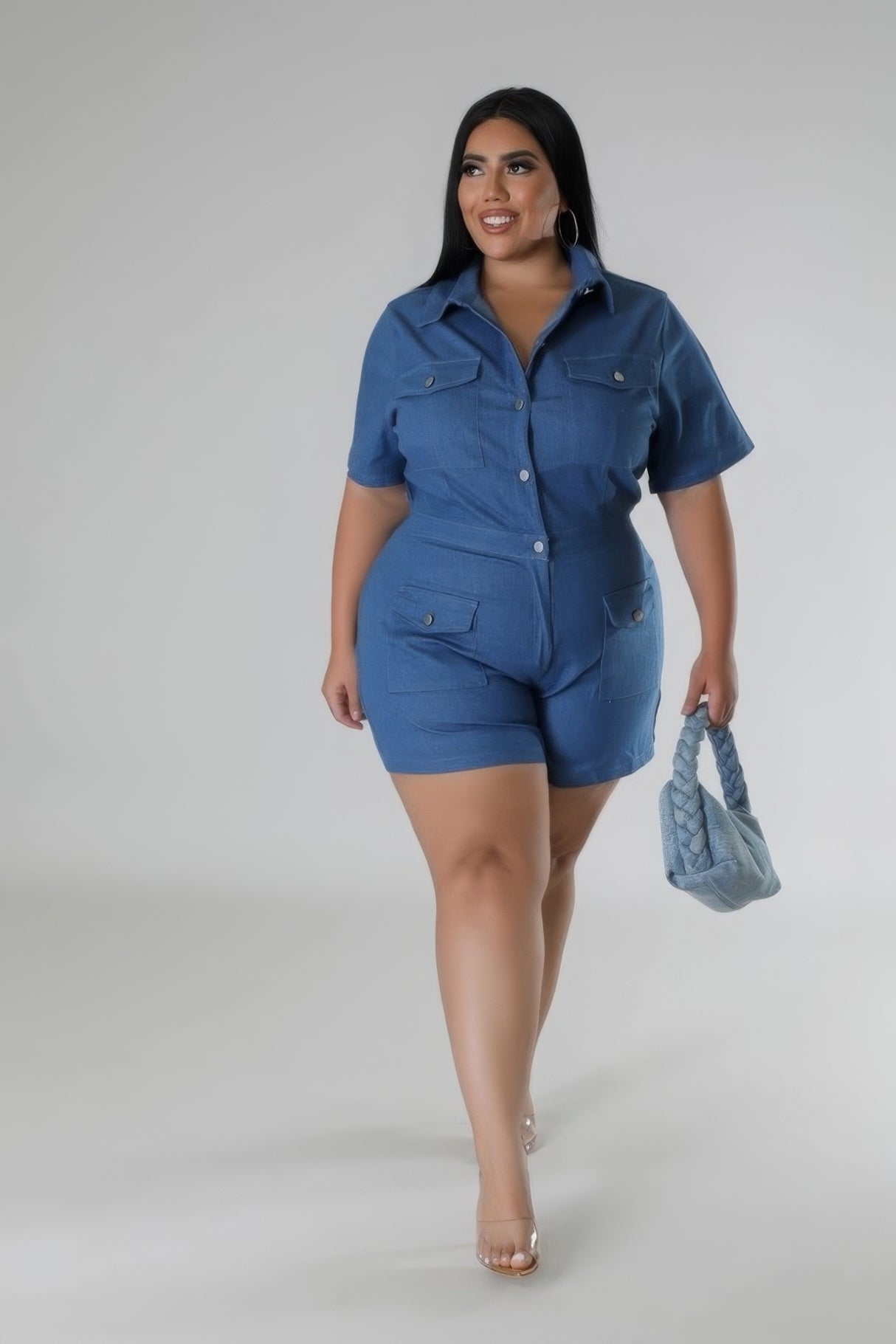 Plus Size Semi-Stretch Denim Romper with model holding light denim purse