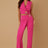 Woman wearing a bright pink outfit with a vest and pants on a beige background