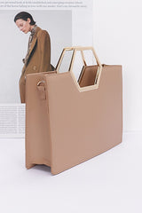 Khaki Structured Top Handle Tote Bag side view with magazine page in the background