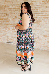 multi-color floral print maxi dress on a plus size model - side view