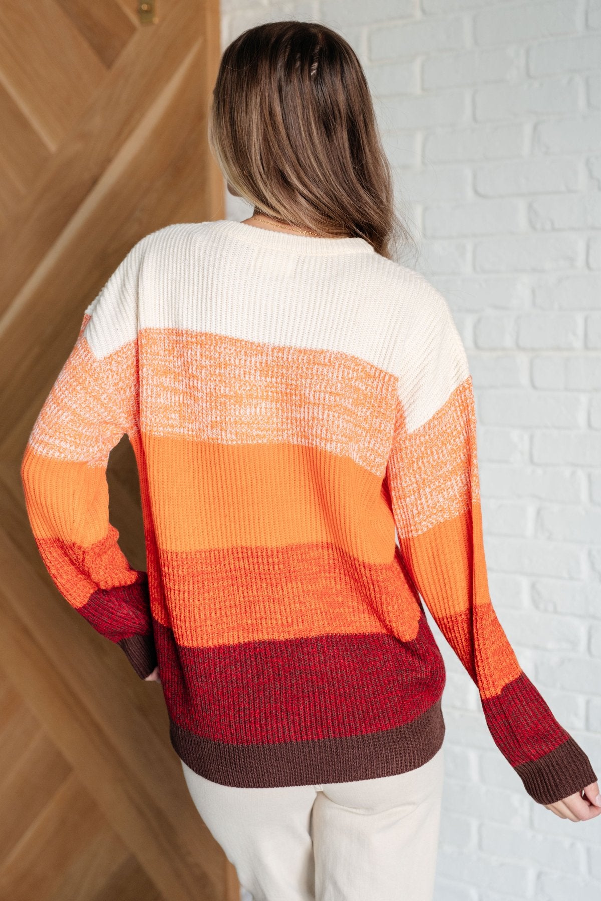 Cozy & Bright different shades of Orange Stripe Color Block Sweater with Burgundy and Brown strips at the bottom back view