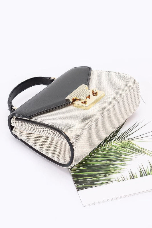 Handbag with black handle and beige body on a white background