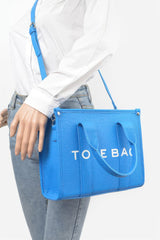 blue Small Faux Leather Tote Bag on a mannequin