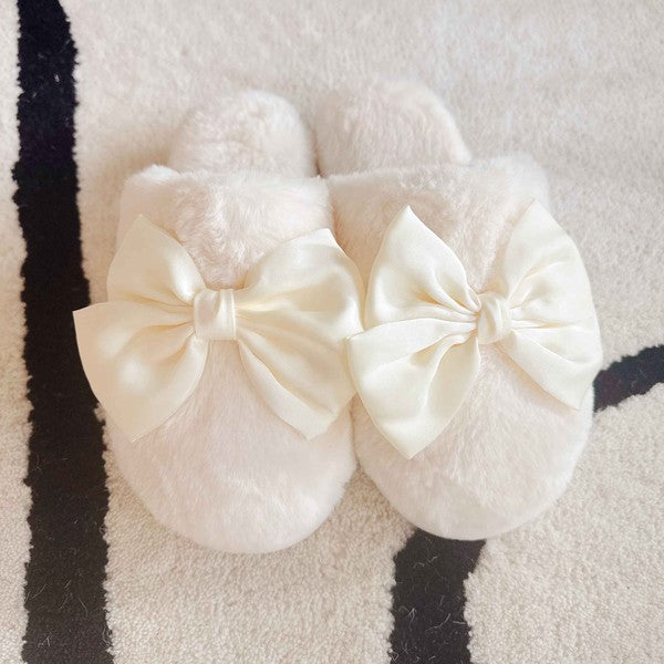 a pair of cream color fuzzy slippers on a light colored rug