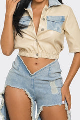 faux leather beige top with cut out denim pants close up