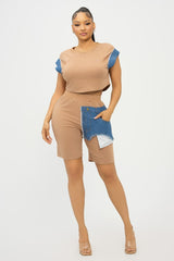Woman wearing a beige outfit with blue accents on a white background