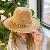 Camel color Panama hat with bold Cuban chain around brim