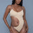 Woman wearing a beige bodysuit against a gray background