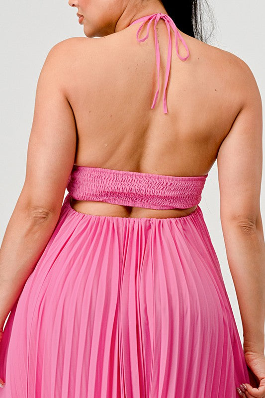 Person wearing a pink halter top and skirt set against a light gray background