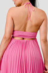 Person wearing a pink halter top and skirt set against a light gray background