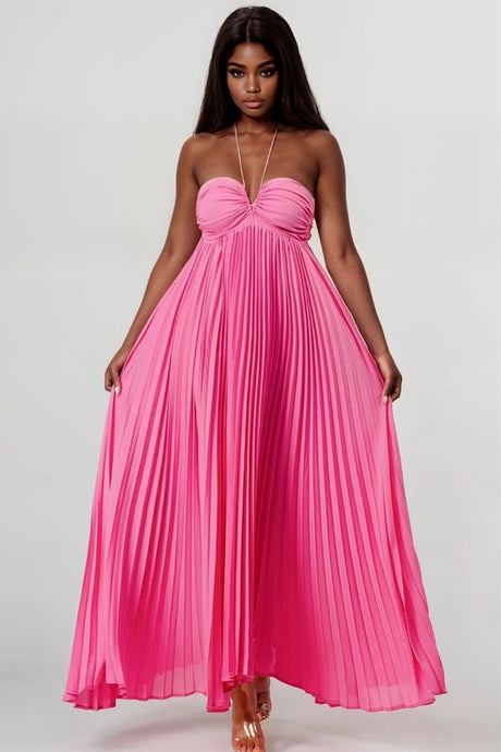 Woman wearing a pink pleated dress on a white background