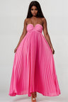 Woman wearing a pink pleated dress on a white background