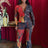 Woman in a colorful Red Leopard Bodycon Jumpsuit standing against a red curtain