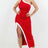Woman wearing a red and white dress with a slit on a white background