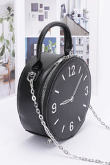 side view of black faux leather clock novelty handbag