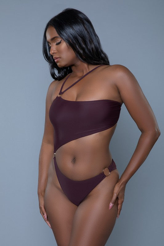 Women's chocolate brown one-shoulder swimsuit with asymmetrical strappy design, cutout detailing, and gold ring accents for a stylish, modern look.