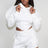 woman wearing a white hoodie and shorts set on a plain background