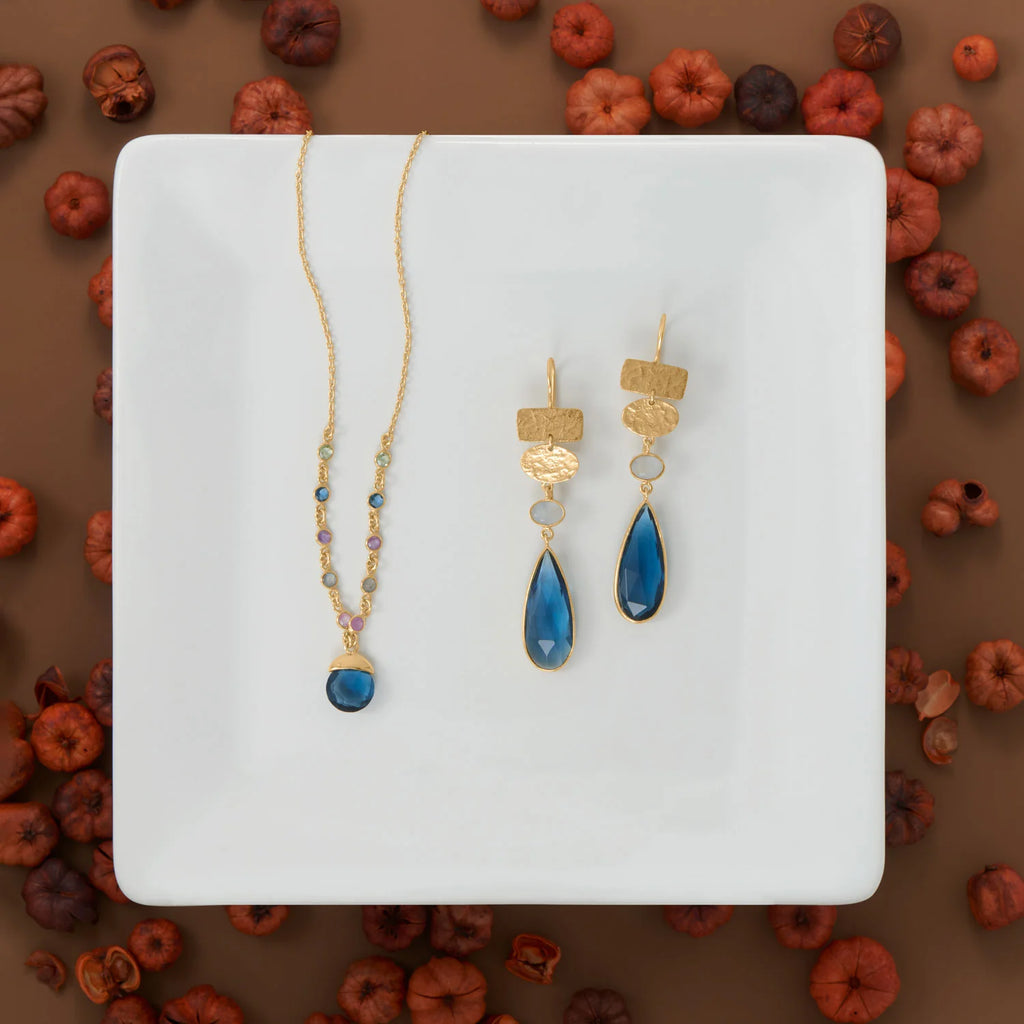 14 karat gold plated sterling silver drop earrings feature 25mm x 10mm blue glass pear drop with a 5mm x 7mm oval chalcedony. Earrings have a hanging length of 66mm.  .925 Sterling Silver 