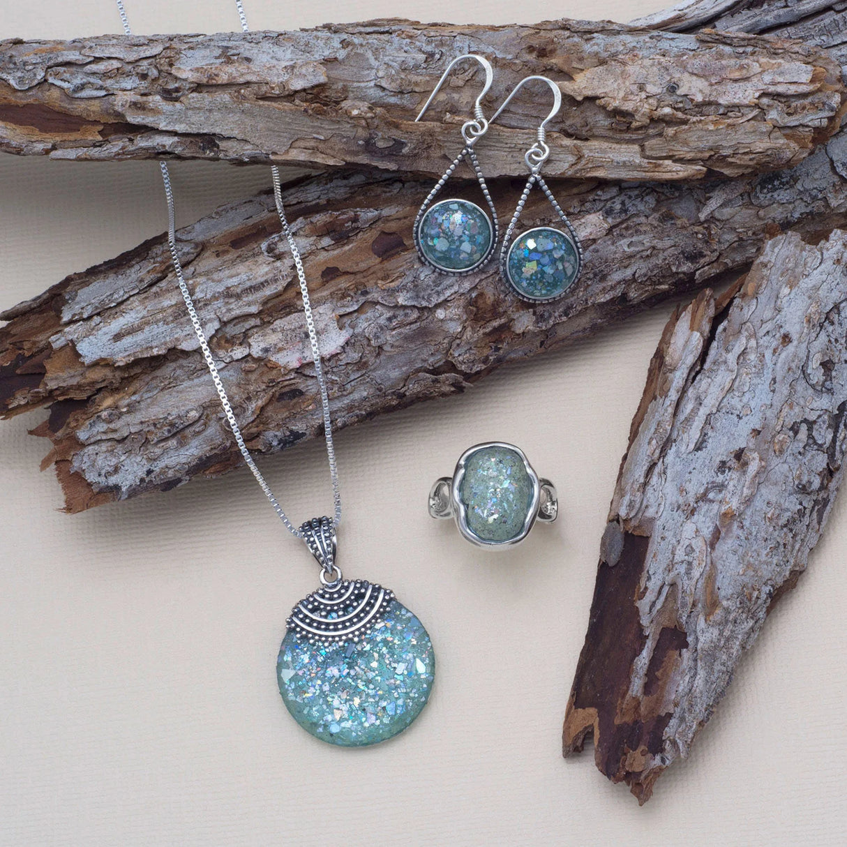 Pear shape sterling silver french wire drop earrings with 11mm round pieces of Roman glass. The earrings hang approximately 37mm.