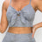 Top: A sleeveless crop top featuring an all-over embossed snake print, front tie, a sweetheart neckline, adjustable cami straps, and a square cut back.  Bottom: A pair of casual skinny leggings featuring an all-over embossed snake print, elasticized high-rise waistband, and a full length. 