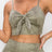 Top: A sleeveless crop top featuring an all-over embossed snake print, front tie, a sweetheart neckline, adjustable cami straps, and a square cut back.  Bottom: A pair of casual skinny leggings featuring an all-over embossed snake print, elasticized high-rise waistband, and a full length. 