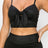 Top: A sleeveless crop top featuring an all-over embossed snake print, front tie, a sweetheart neckline, adjustable cami straps, and a square cut back.  Bottom: A pair of casual skinny leggings featuring an all-over embossed snake print, elasticized high-rise waistband, and a full length. 