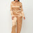 model wearing gold Zip Front Satin Cargo Jogger Jumpsuit