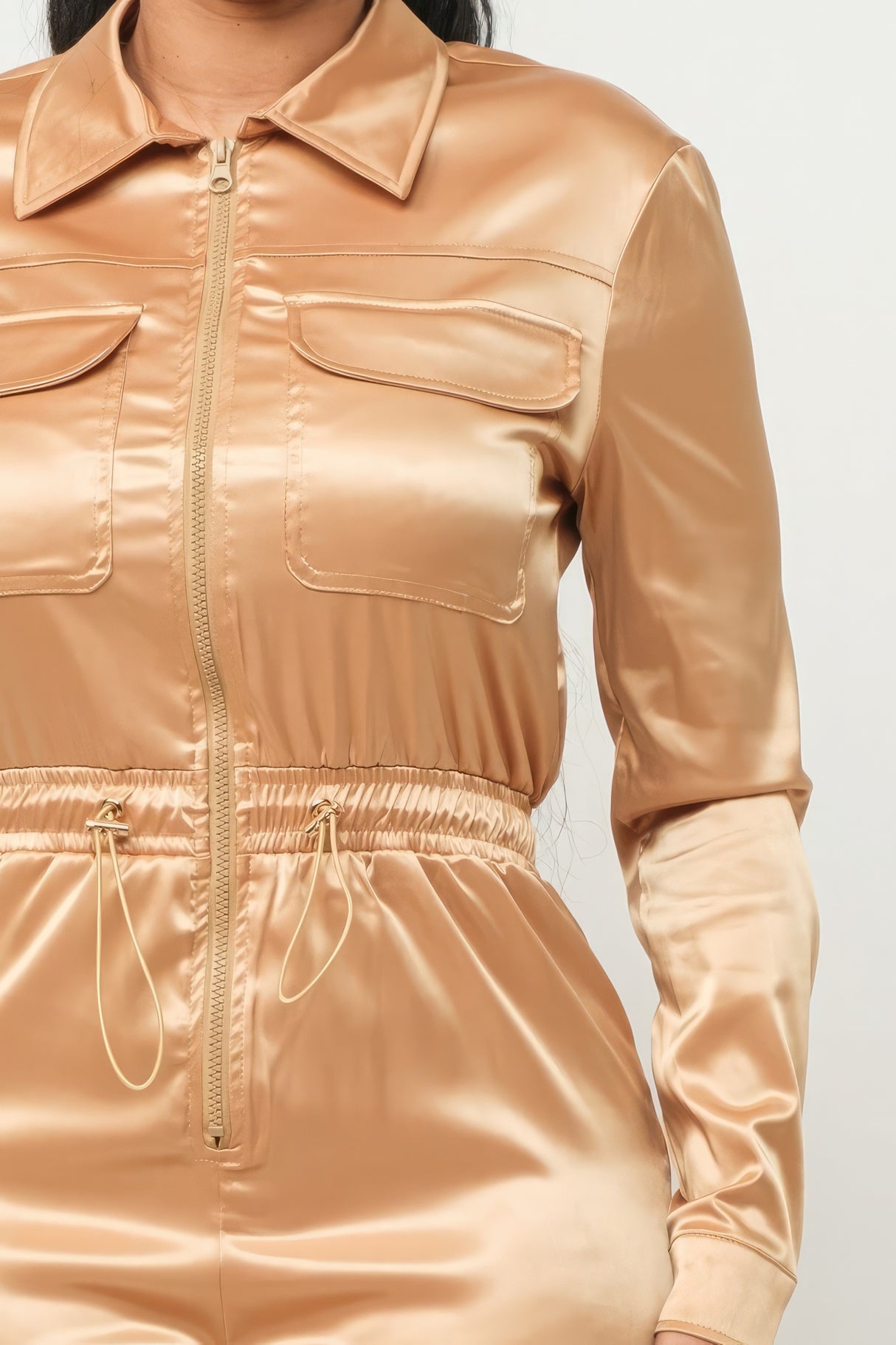 close up of model wearing gold Zip Front Satin Cargo Jogger Jumpsuit