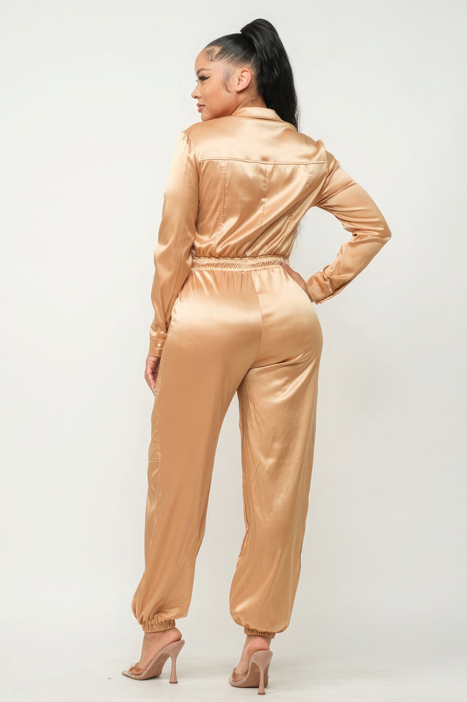 back view of model wearing gold Zip Front Satin Cargo Jogger Jumpsuit