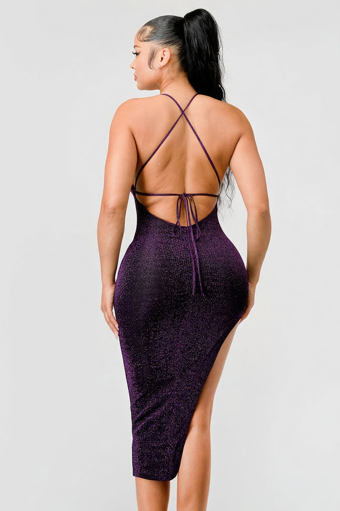 back view of model wearing a purple metallic glitter side slit midi dress