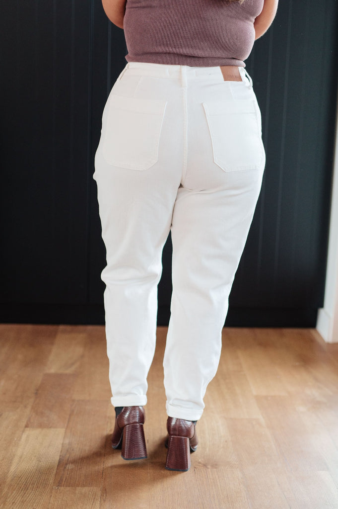 back view of plus size model wearing Classic High Rise Judy Blue Joggers in Off White with brown boots